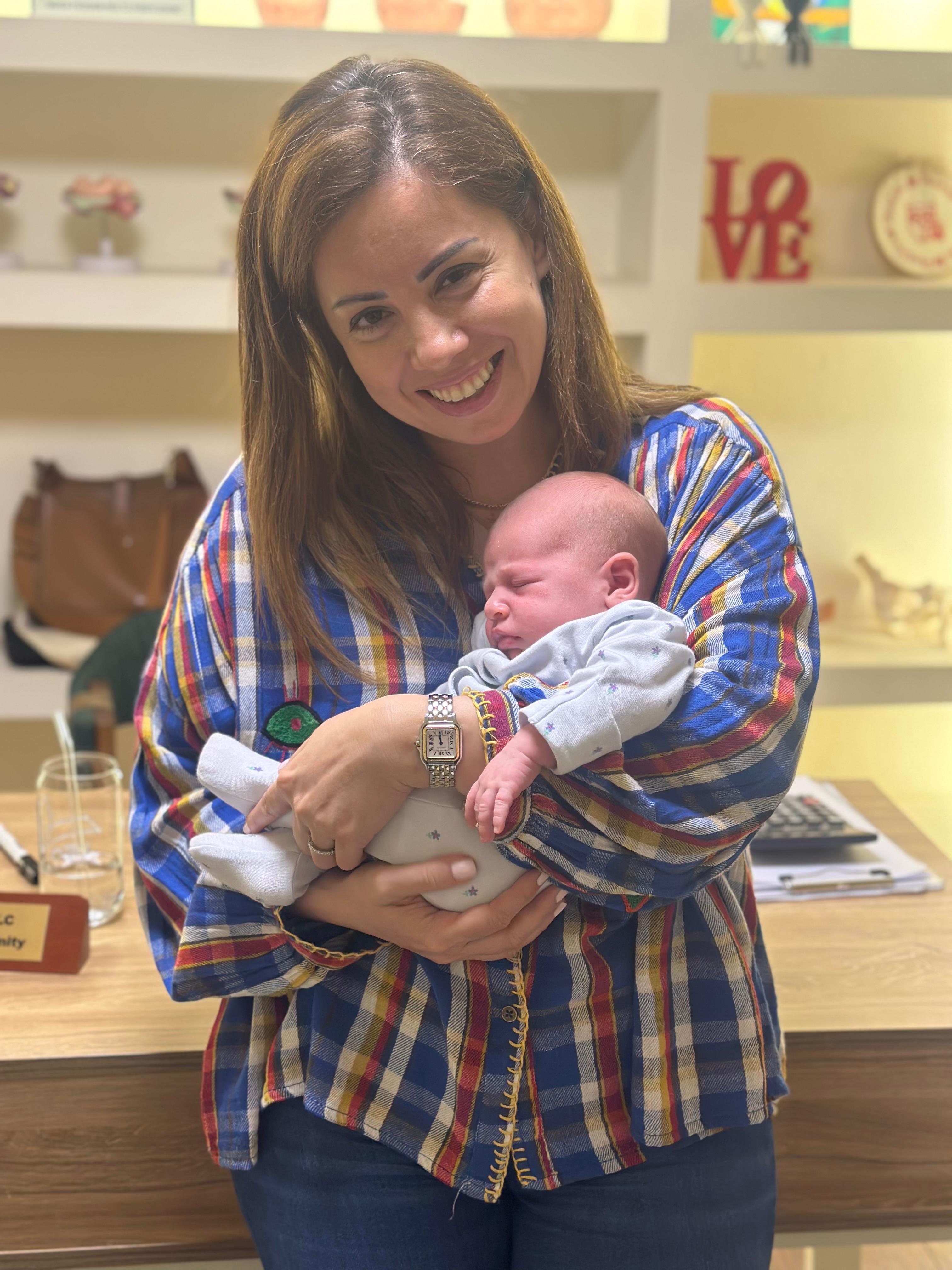 New mother holding her newborn baby at Sophia Maternity